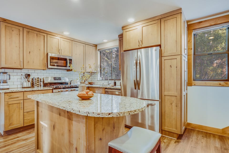 Kitchen features an island and modern appliances.