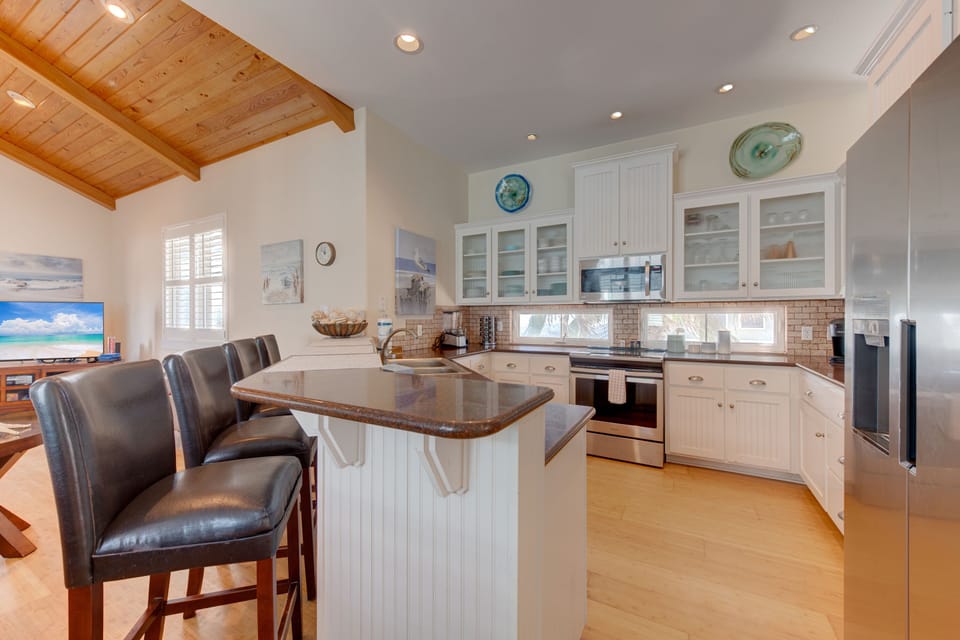 Your gourmet kitchen features granite counters, stainless appliances, and exposed beam ceilings for memorable meal prep.