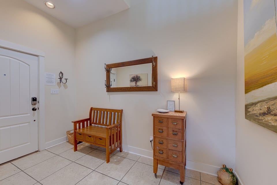 Step into your welcoming entryway, where warm wood furnishings and soft lighting create an instantly calming atmosphere after your travels.