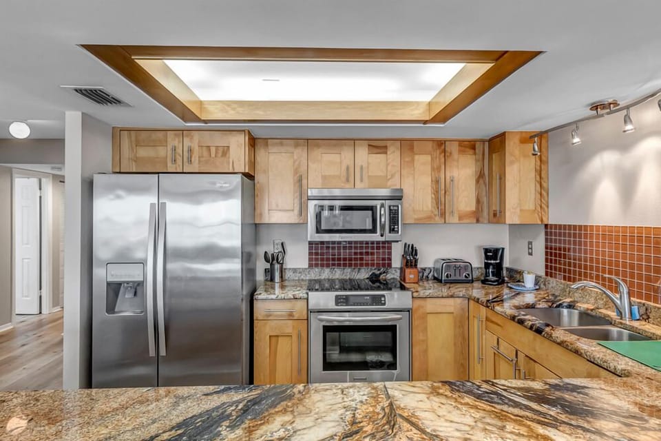 - Fully stocked kitchen features modern stainless steel appliances, custom wood cabinets, and granite surfaces
- From morning coffee to late night snacks, everything is within reach
- Perfect setup for short or long term stays