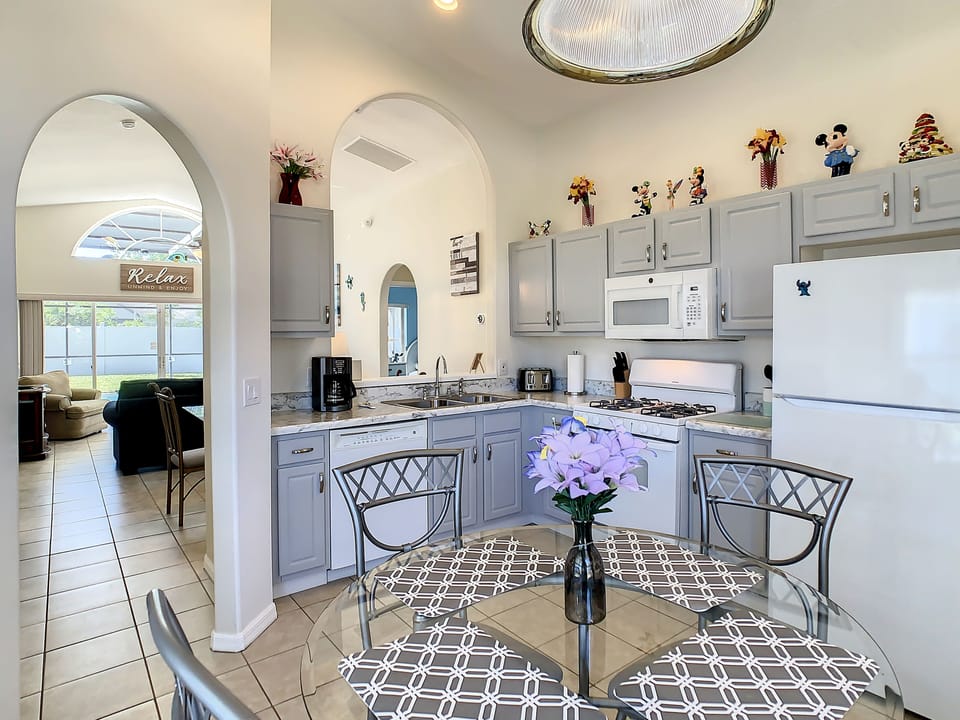 Bright kitchen with modern appliances and a charming dining area.