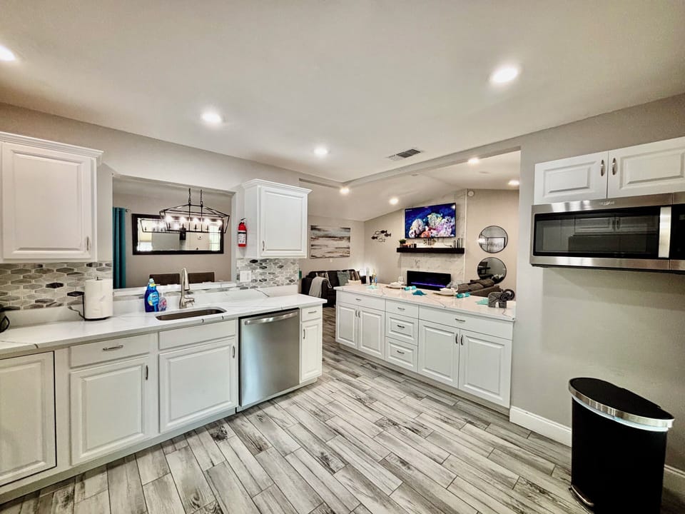 Large kitchen with pots, pans, crockpot, toaster, coffee, pot, spices