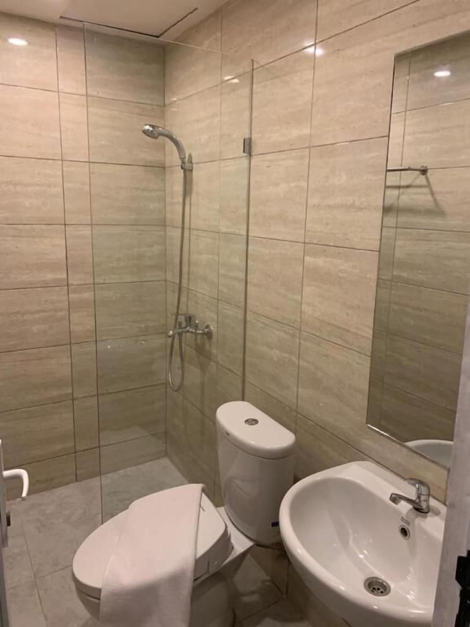 Shower, rainfall showerhead, hair dryer (on request), slippers