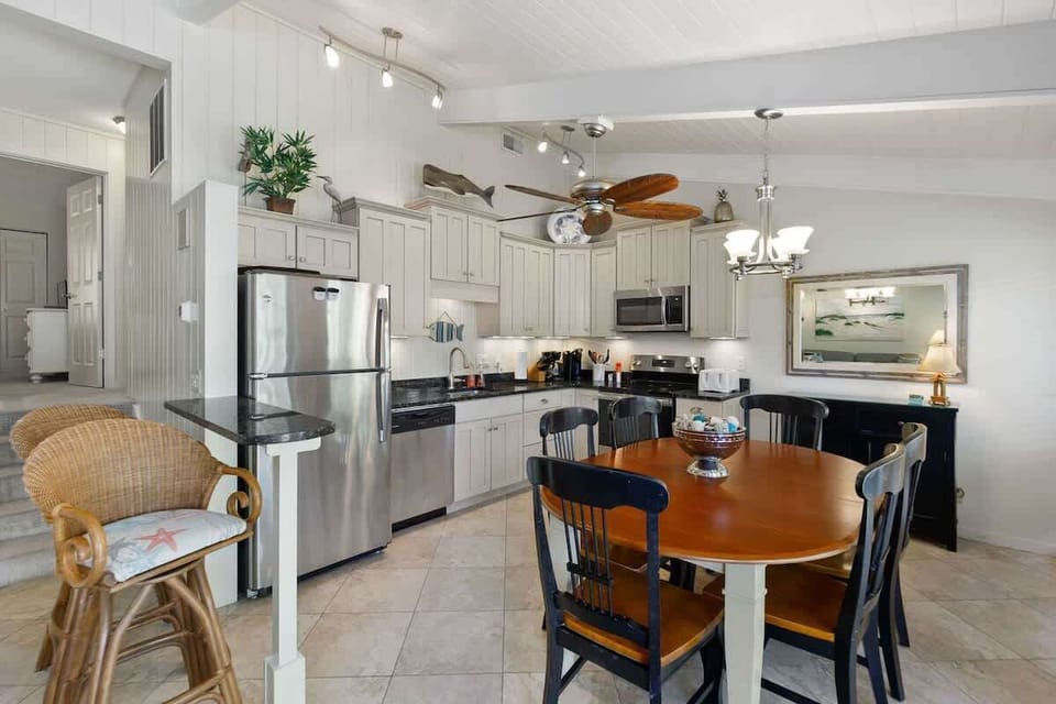 Your fully equipped kitchen features granite countertops, stainless appliances, and casual dining space perfect for preparing meals together.