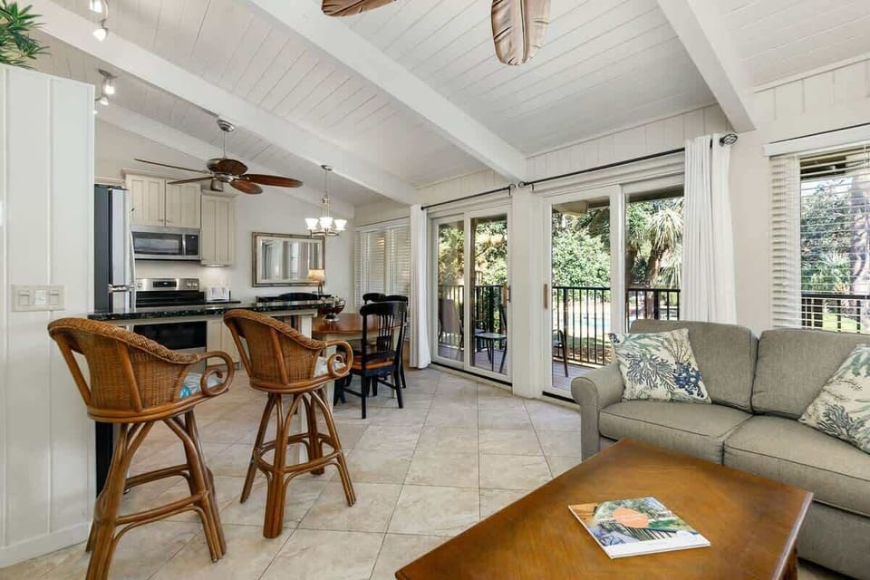 Relax in your bright, open-concept space where coastal charm meets comfort—perfect for morning coffee at the breakfast bar or evening gatherings.