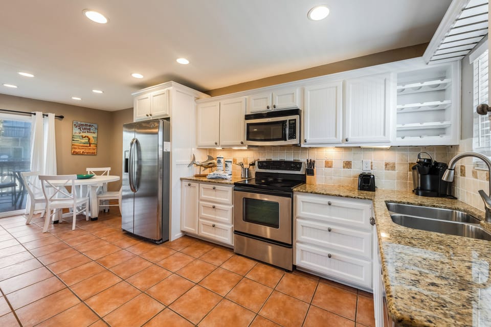 Your fully equipped kitchen features granite countertops, stainless steel appliances, and everything needed to create memorable meals during your stay.