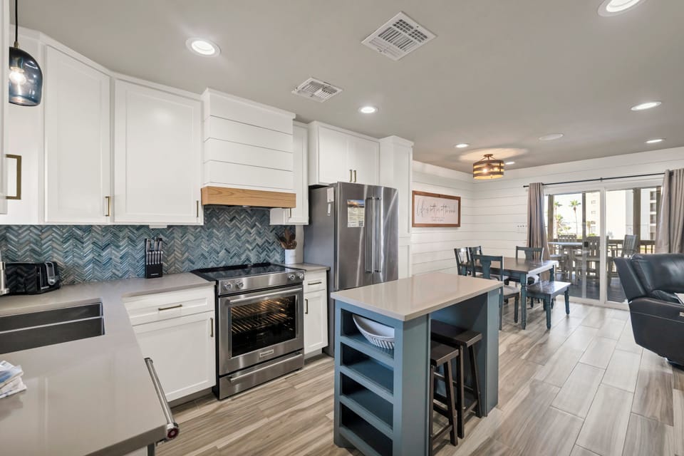 Your modern kitchen awaits with sleek white cabinets, granite counters, and a stylish island perfect for morning coffee or meal prep together.