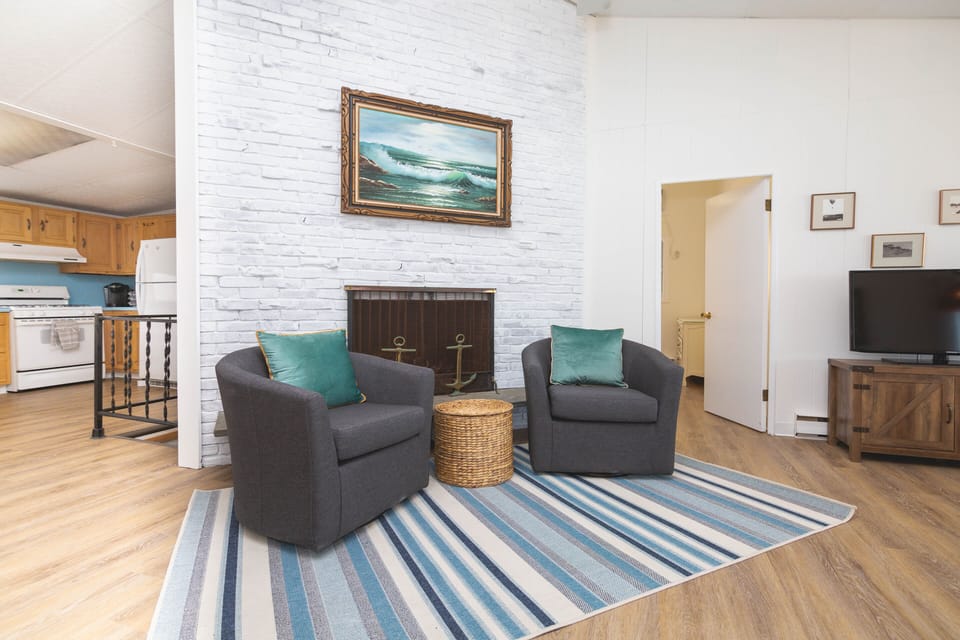 Enjoy the decorative fireplace and original  artwork throughout the home
