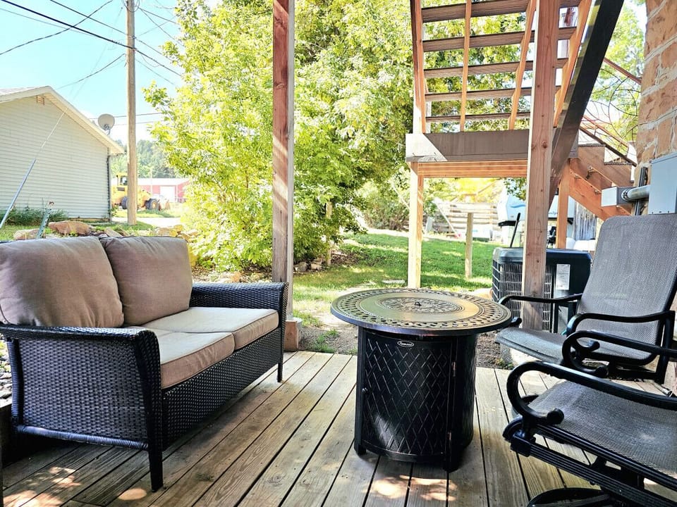 Back patio with fire table and seating. (Additional seating not pictured)