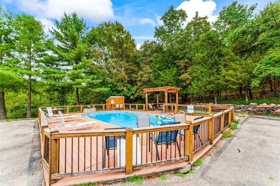 Outdoor community pool area, lounge chairs and plenty of trees create a relaxing space for families to come and play!