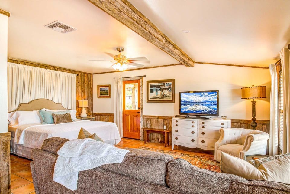 Mucho Gusto's spacious master bedroom includes a king-sized bed, plush seating area, and satellite TV, too!