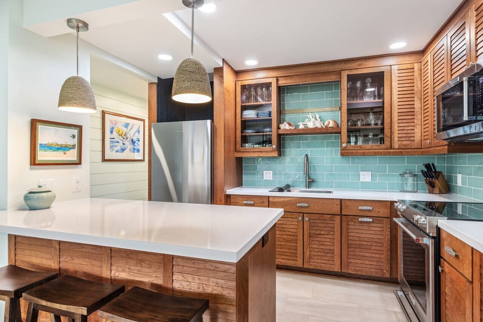 Bright kitchen w/ wood cabinets & teal backsplash for a fresh, coastal feel.