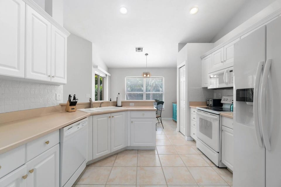 The kitchen resides just behind the living room wall with open access on either end.