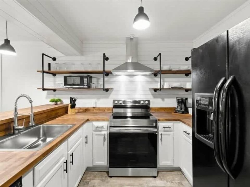 Modern appliances and open shelving create a perfect space for culinary adventures!
