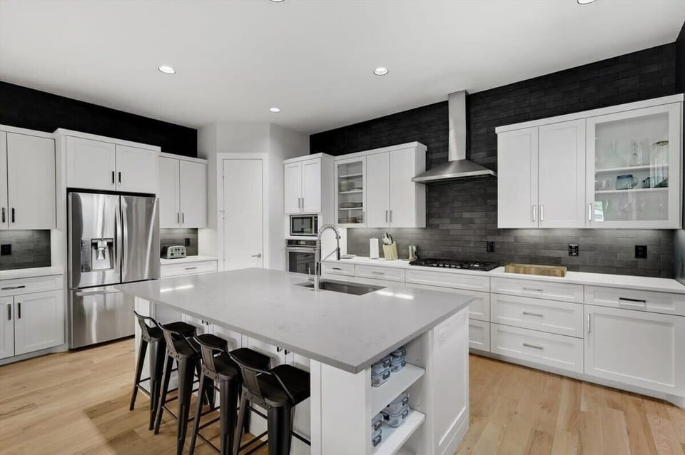 Prepare to be transported to a world of culinary bliss with this classic kitchen island, top-of-the-line appliances, and sleek countertops!