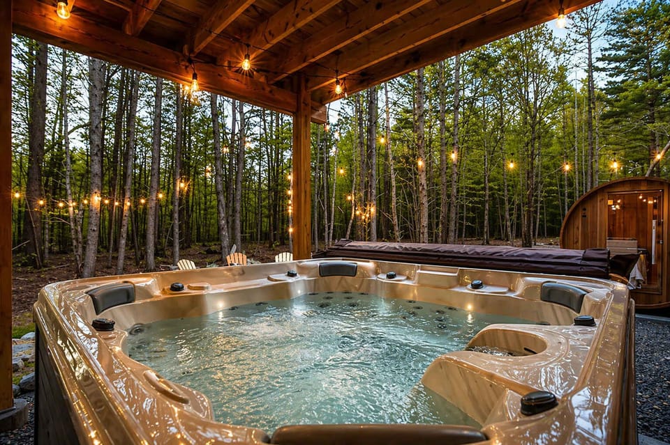 Outdoor Hot Tub Under String Lights in Forest Setting
