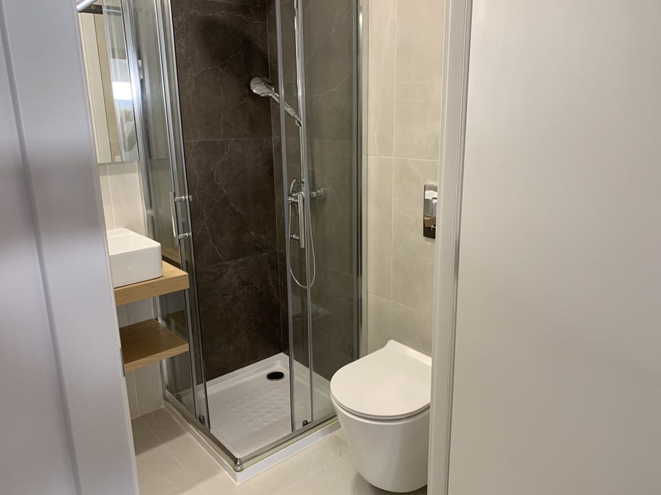 Economy Double Room, 1 Queen Bed | Bathroom | Shower, rainfall showerhead, hair dryer, towels
