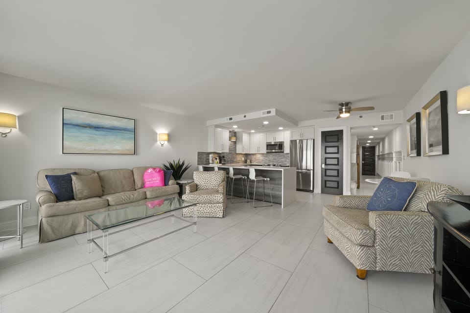 Renovated beachfront vacation rental living space with open kitchen, dining, and lounge area