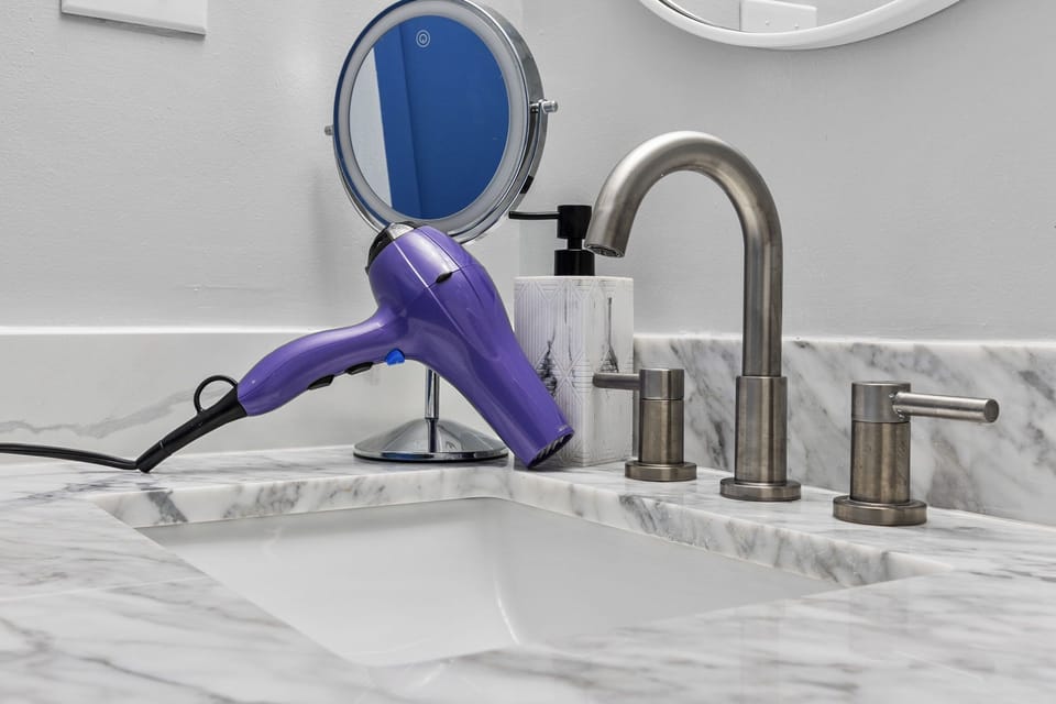 Backlit mirror and hair dryer available for you as a complimentary amenity 