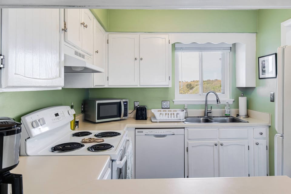 Spacious kitchen with stove, microwave, dishwasher and refrigerator