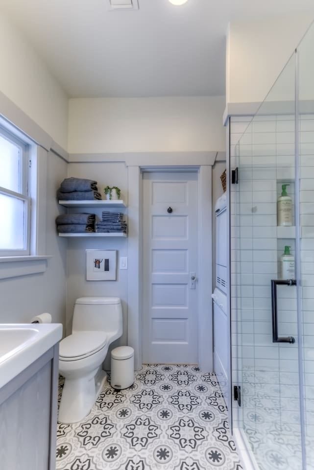 Bathroom with shower, compact washer and dryer