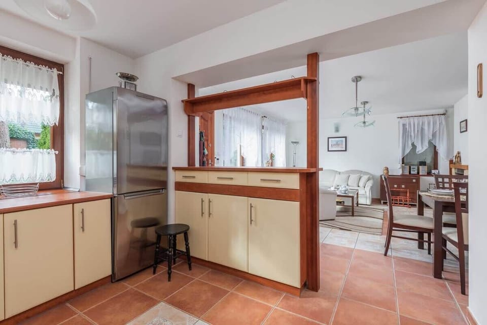 A view of the kitchen with ample counter space, modern appliances, and natural light from a window.