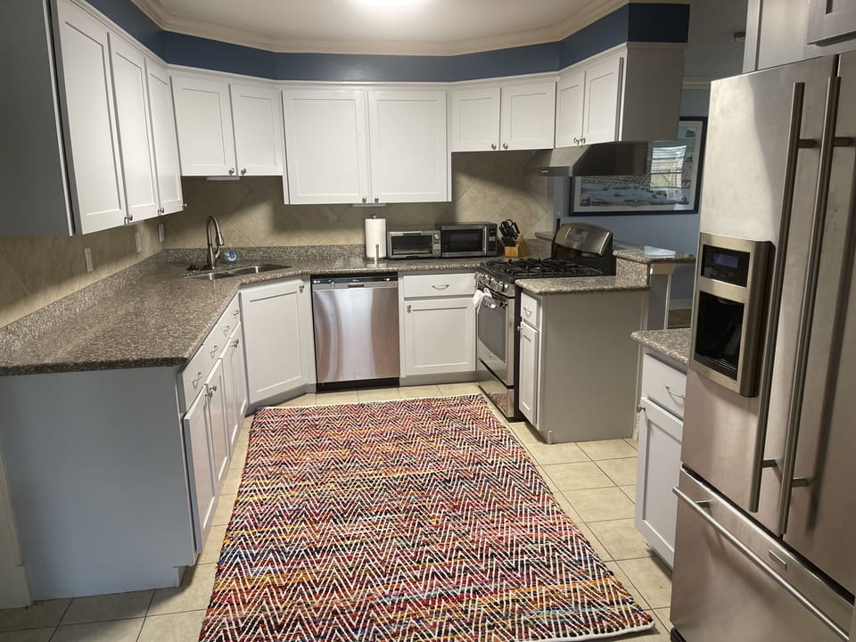 The spacious kitchen comes fully equipped with high-end appliances