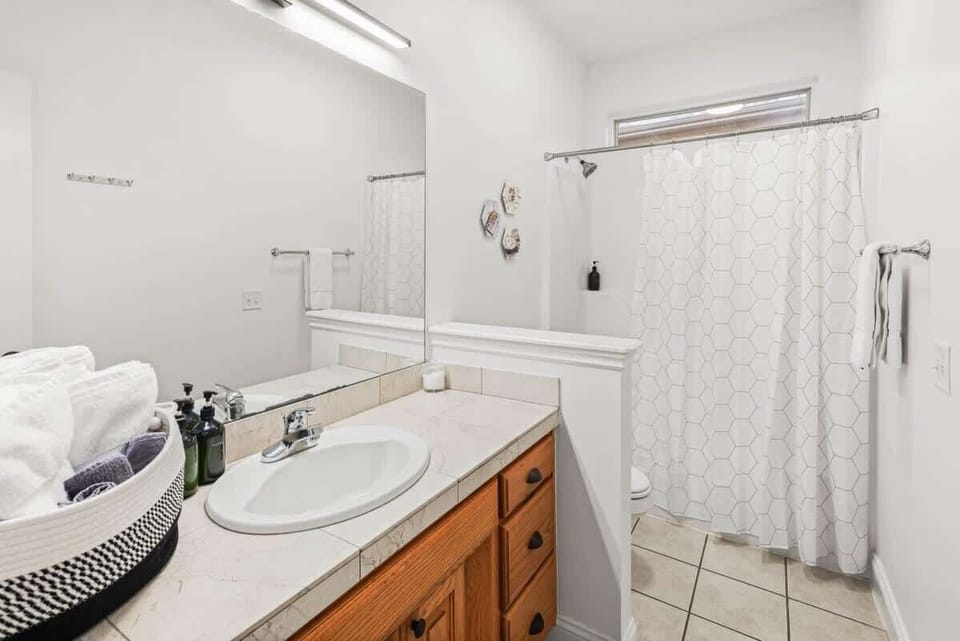 Spotless bathrooms with tub/shower combos, plush towels & essential toiletries—everything you need for a comfortable stay.