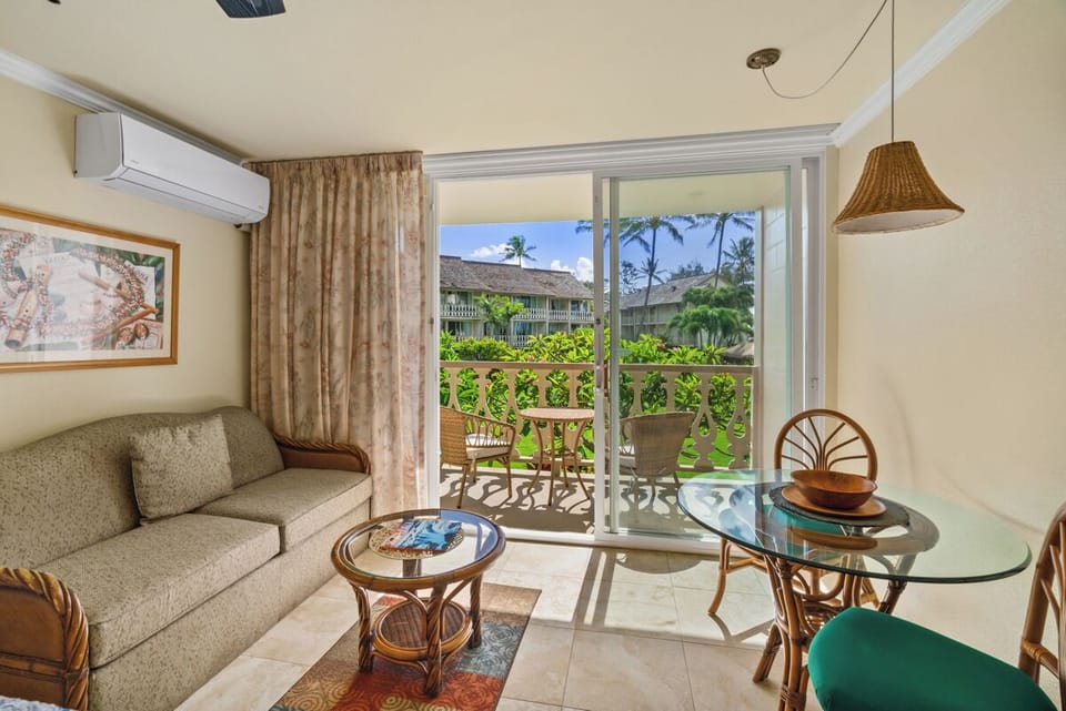 Unit#240 - sitting area with a coffee table and breakfast table with two chairs