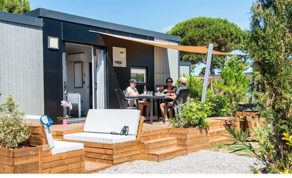 Modern camping home with a stylish deck, perfect for lounging and enjoying the outdoors.
