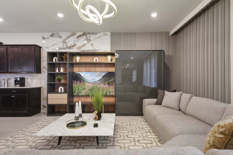 Modern living room with cozy sectional, marble coffee table, and stylish decor.