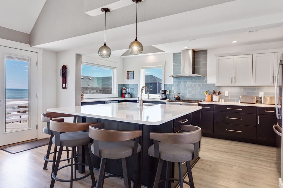 Whip up some fresh, local seafood in the Gourmet Kitchen with a commercial oven/range, sparkling quartz countertops, and plenty of prep space, including a prep sink and an ice maker.