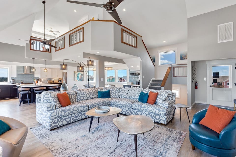 Relax in the Main Living Area in one of the cozy couches or modern chairs with ocean views and plenty of unique, minimalist light fixtures curated for a calm, relaxing environment.