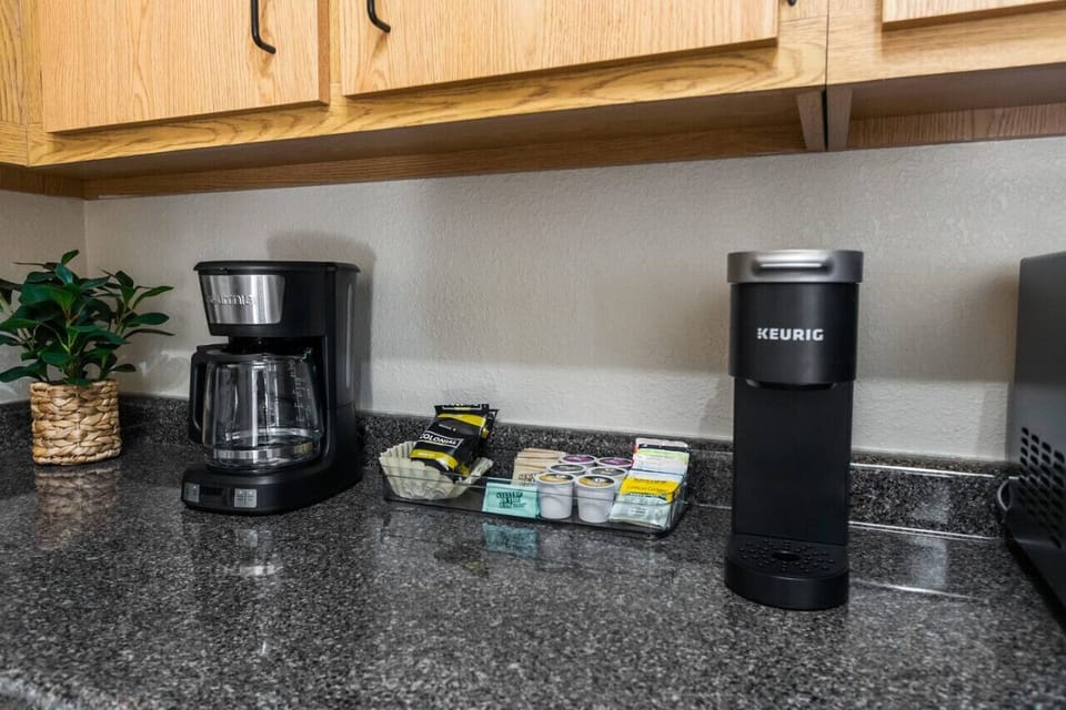 Coffee bar includes all the essentials for your morning brew including a 12 cup coffee maker and a Keurig. A starter pack of ground coffee, K-cups, tea, creamer, sugar and stevia are provided. Enjoy!
