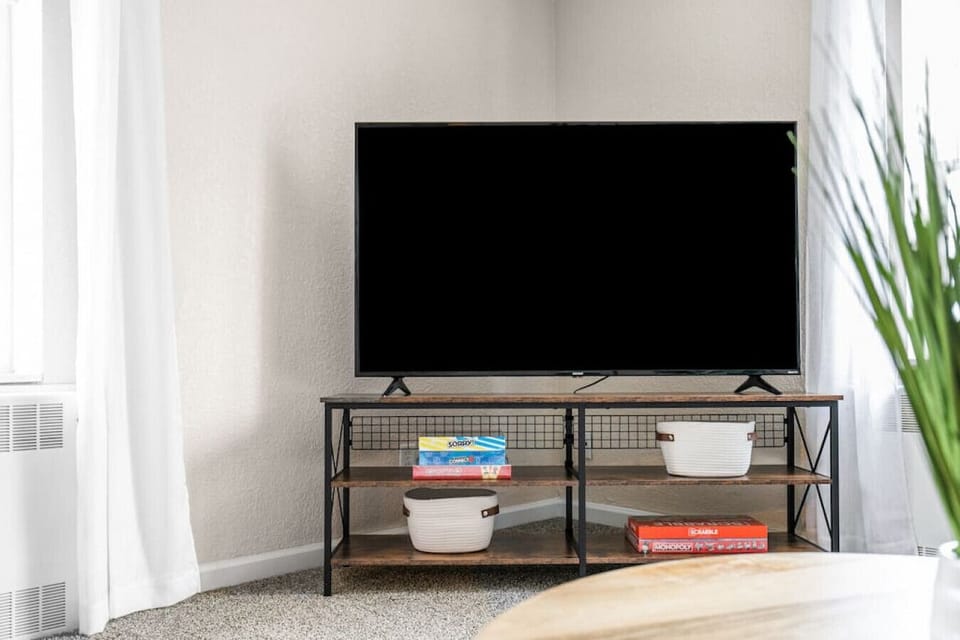 65` Roku TV in the living area. Games for all ages are available in the tv stand.