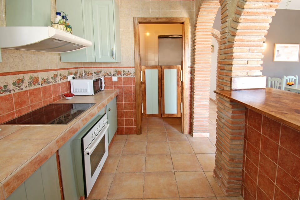 The room houses the washing machine, fridge/freezer and a dishwasher. 