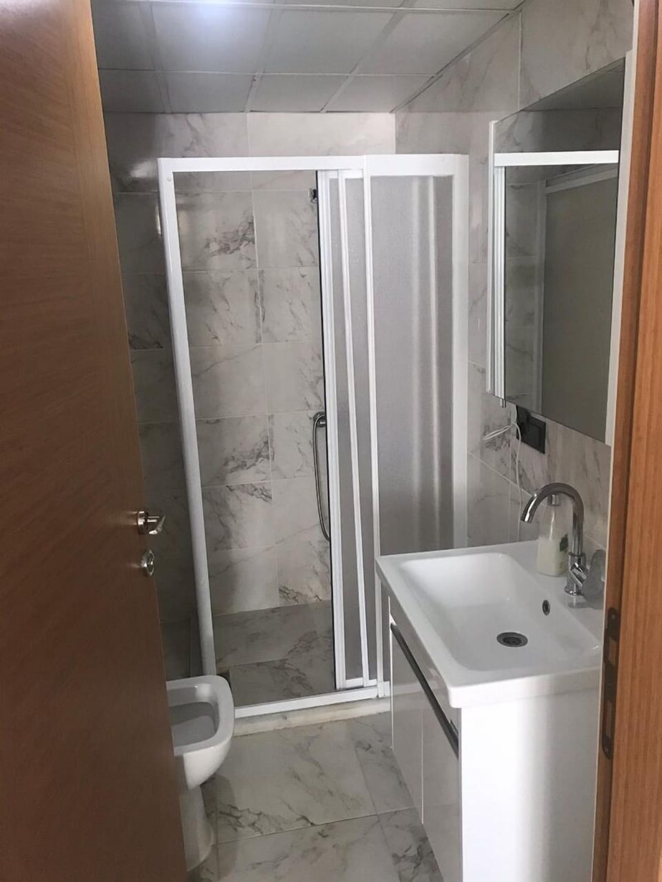Shower, hair dryer, slippers, towels