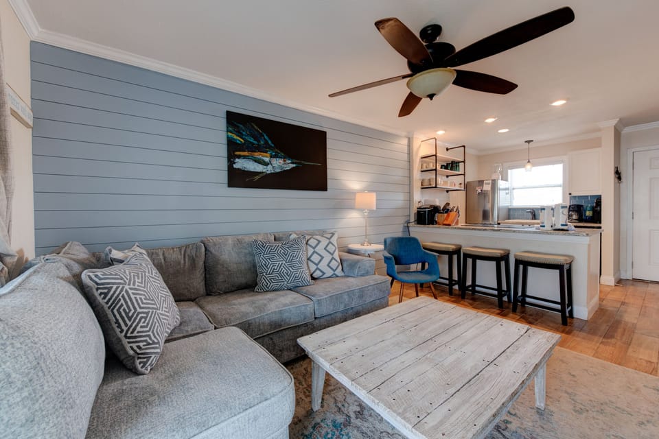 Sink into the plush sectional and feel at home in this stylish living space with coastal vibes and modern comfort.