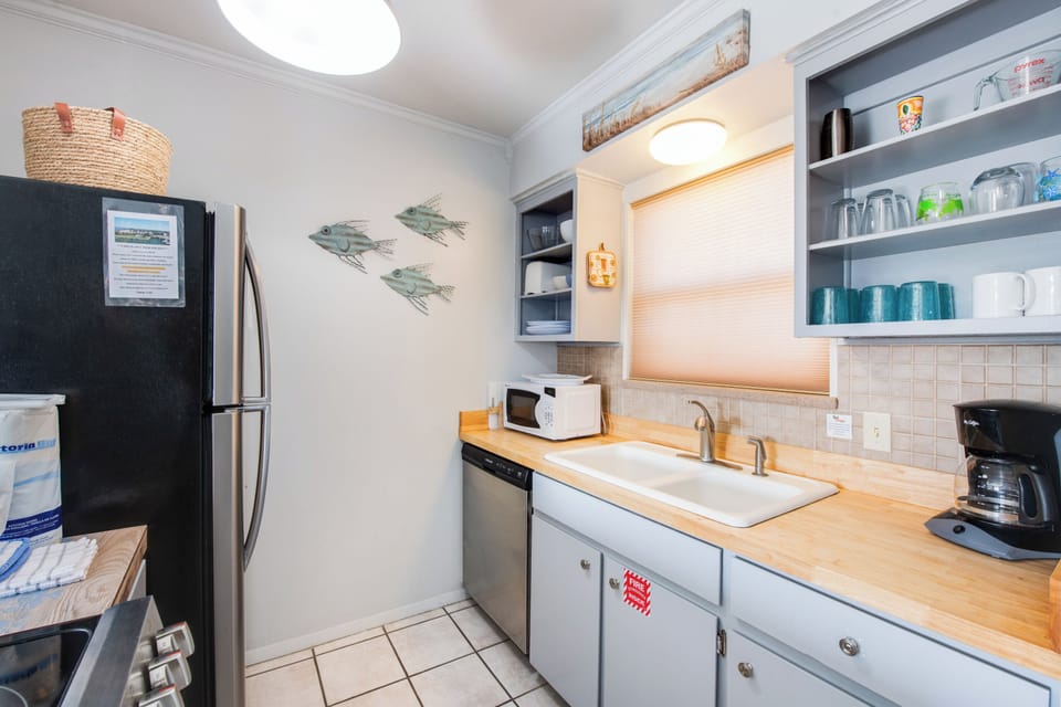 Your fully equipped kitchen features modern appliances and coastal charm, perfect for preparing meals during your beach getaway.