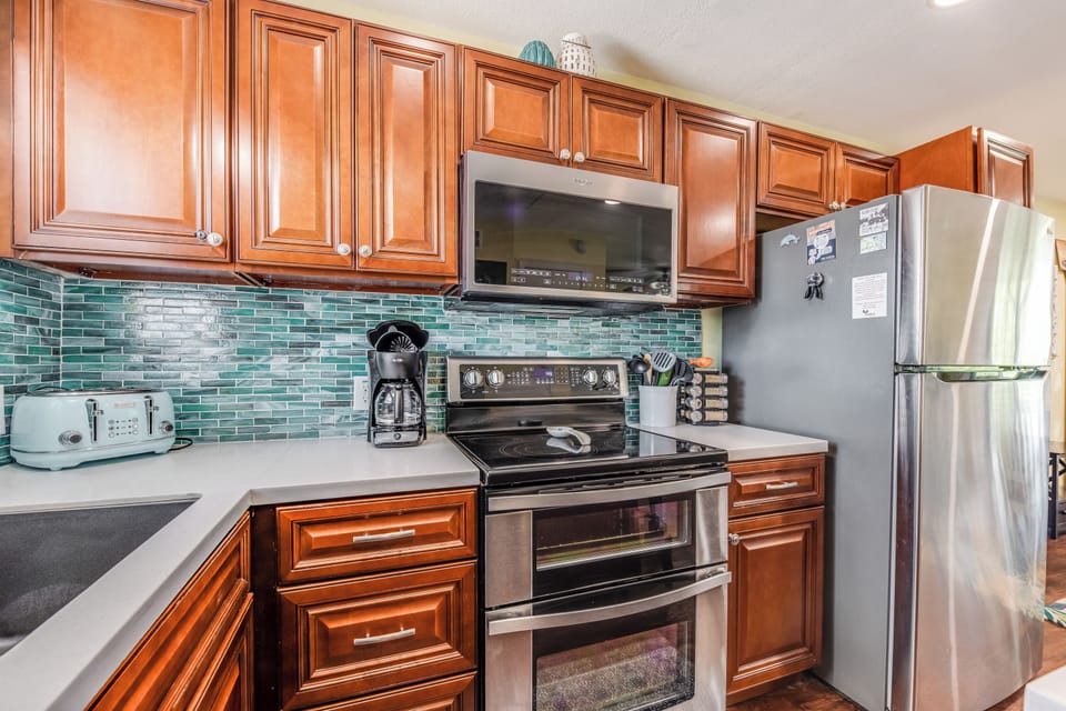 Your fully equipped kitchen features stainless steel appliances and beautiful cabinetry, perfect for preparing meals during your stay.