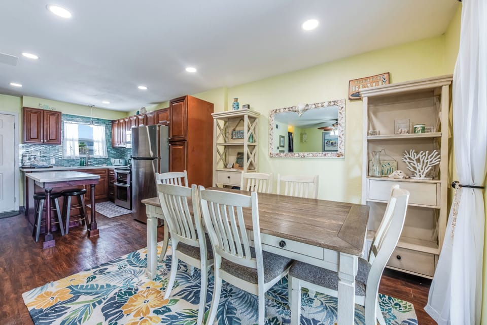 Your open dining space flows into a fully equipped kitchen with coastal charm and comfortable seating for memorable meals.
