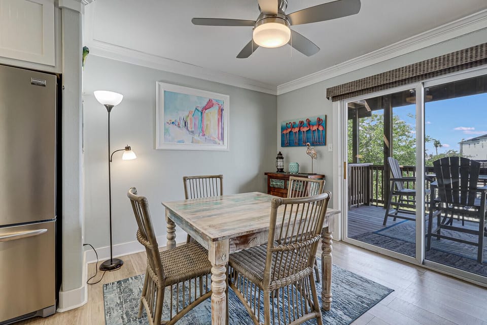 Gather around this charming dining table where coastal artwork and natural light create the perfect atmosphere for your morning coffee or evening meals.