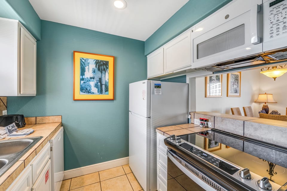Your fully equipped kitchen invites you to create memorable meals with modern appliances and coastal charm.