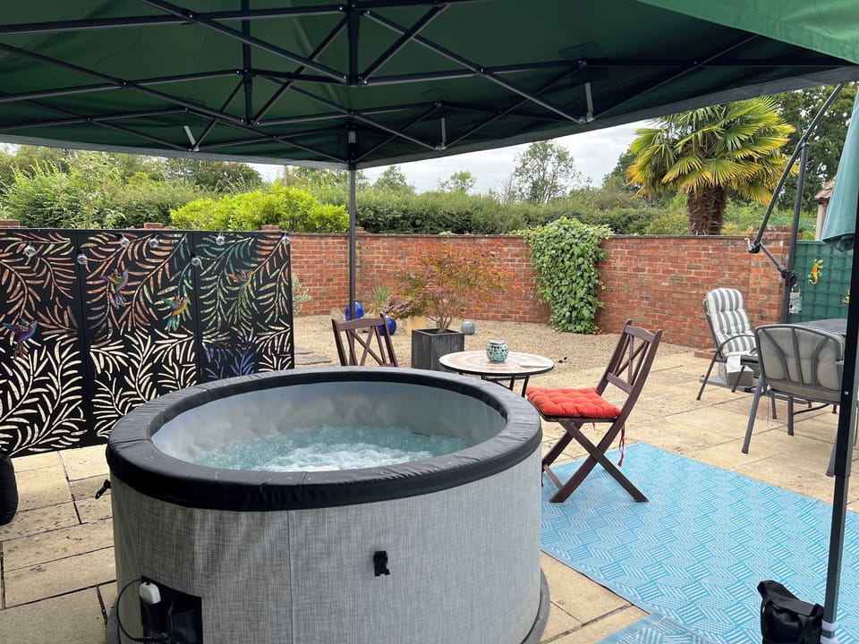 South facing walled courtyard with covered  Spa Pool and outdoor dining