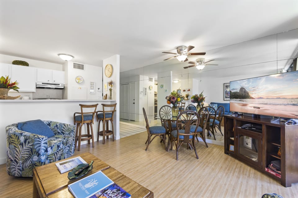 Open living area blends kitchen, dining, and relaxation zones with coastal-inspired décor, inviting you to enjoy shared moments together.
