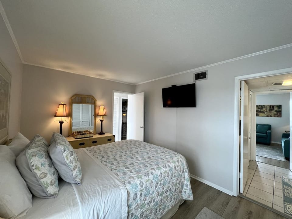 Drift into restful sleep in your peaceful bedroom, complete with cozy linens, warm lighting, and entertainment at your fingertips.