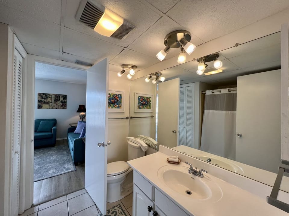 Your bright bathroom features modern lighting, a spacious vanity, and convenient access to your comfortable living area.