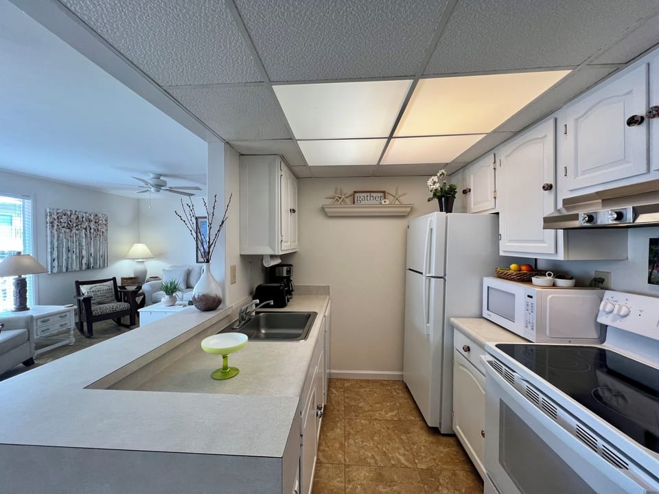 Your fully equipped kitchen opens to the living area, perfect for preparing meals while staying connected with your loved ones.