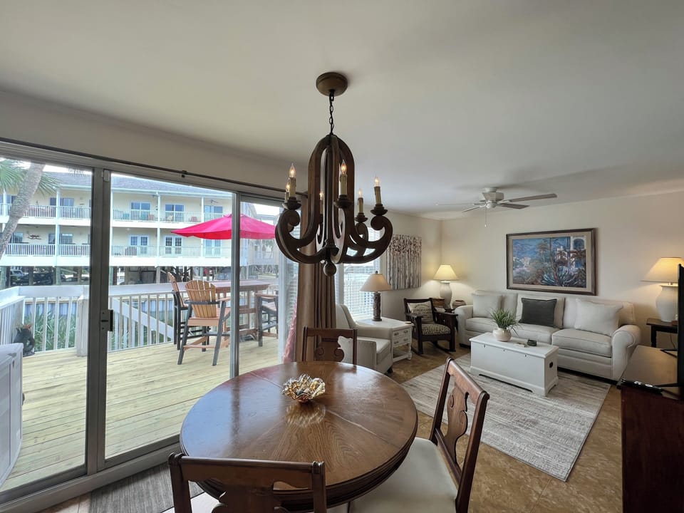Relax in your bright living space with elegant chandelier lighting and step onto your private deck for outdoor dining moments.