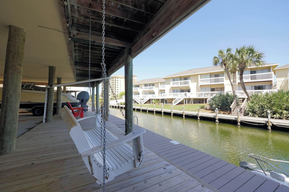 Relax on your private waterfront dock with a gentle swing overlooking the peaceful marina and tropical palms.